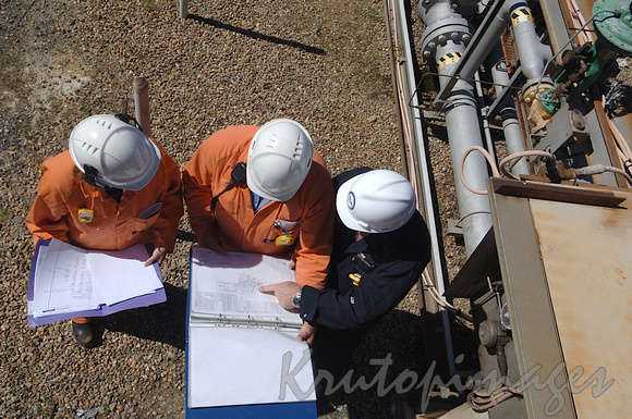 engineers on worksite at refinery discuss the plans-above shot-2