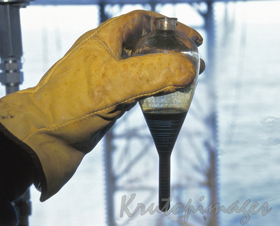 offshore oil sample  in hand.