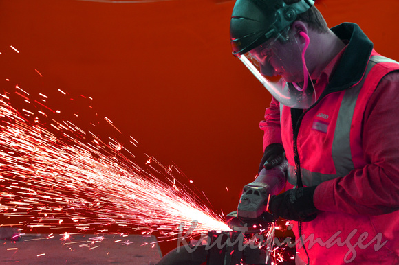 Angle Grinder in use worker in PPE.
