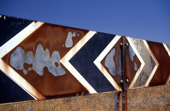 T intersection signage -weathered after many years in the hot Northern Territory sun