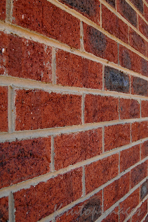detail of a high red brick wall perspective view