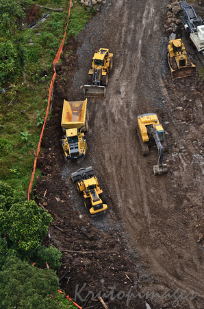 PNG- aerial over heavy machinery constructing roads in the highlands of Papua New Guinea-PNG-LNG project