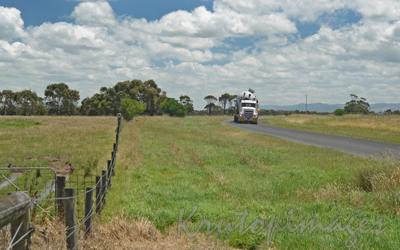 Heavy vehicle transporting large steel vessels on country Victorian road