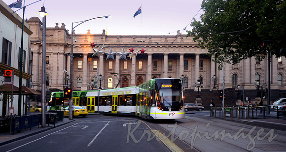 new style Melbourne articulated tram passes Treasurey Place
