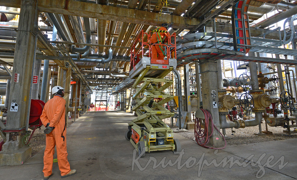 Overhead cabling is installed in a refinery