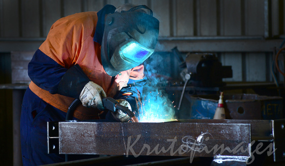 welder at work up close to weld in maintenance workshop-2