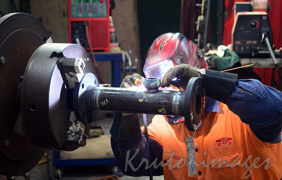 welder at work up close to weld in maintenance workshop