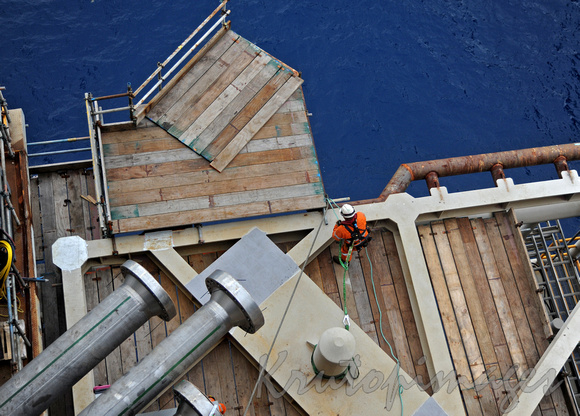 overhead view of an offshore rigger preparing a platform to accomodate a crossover bridge towork vessel.