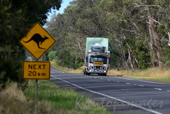 Watertank carried on a country road with signage warning of kangaroos