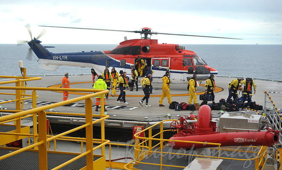 Offshore workers disembark helicopter