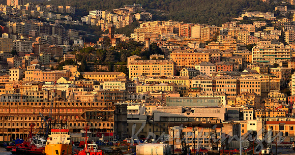 The city of Genoa at sunset seen from the harbour during a cruise