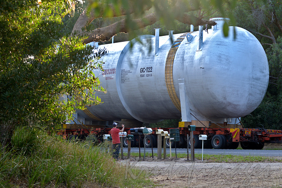 in rural Victoria alocal waves to passing driver and huge vessel on route to a refinery