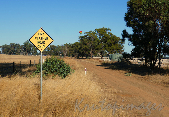 dry weather road and hot air balloon in rural Victoria near Yarrawonga