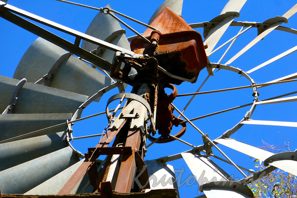 detail of an old irrigation windmill stands on a border property in Yarrawonga