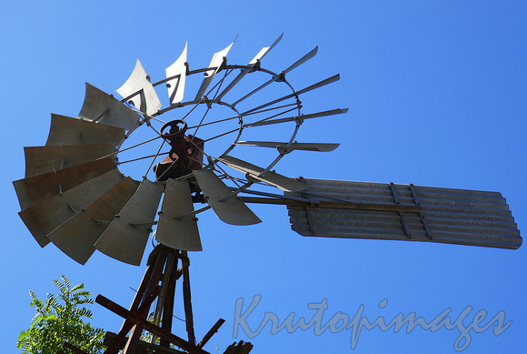 old irrigation windmill stands on a border property in Yarrawonga