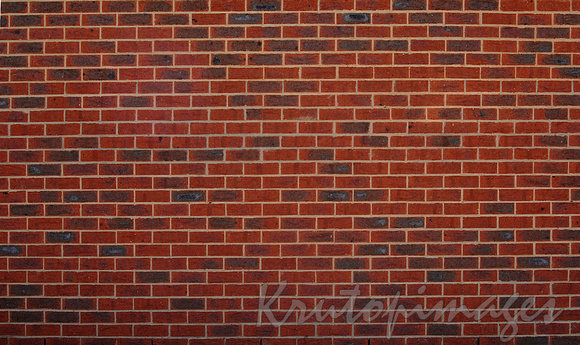 detail of a high red brick wall horizontal view