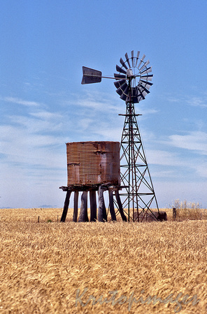 OLd remote water irrigation wndmill and tank on a outback wheat property
