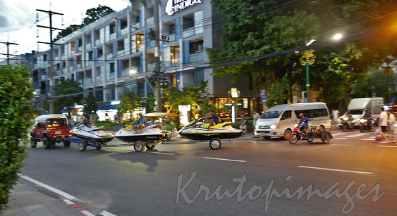 Thailand-Phuket main road a convoy of jetskis is towed through the area