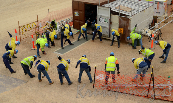 workers on site prior to days work exercise on site wearing ppe