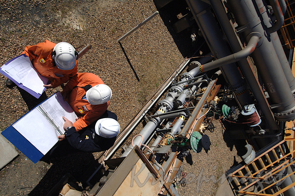 engineers on worksite at refinery discuss the plans-above shot