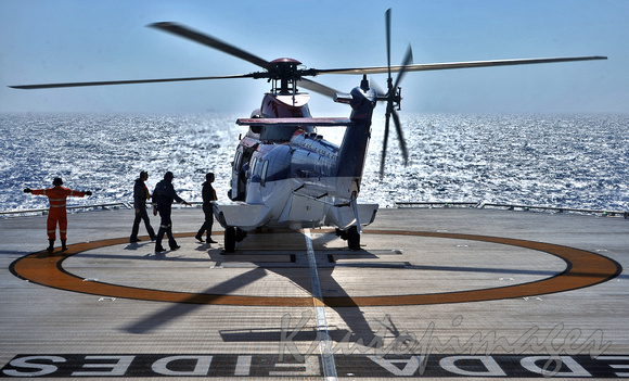 Offshore crew change by helicopter-crew embark vehicle on the helipad of the Edda Fides