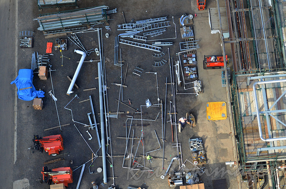 Construction worker sort components in a storage yard aerial