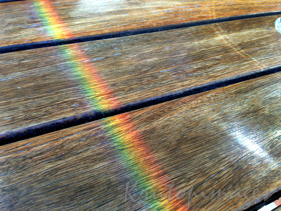 rainbow reflection on timber boards
