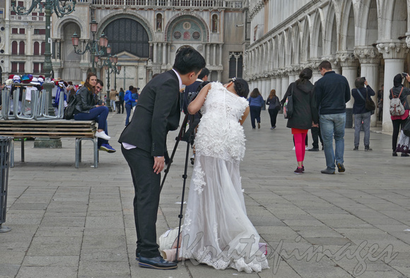 Venice, bride and groom check photo angle