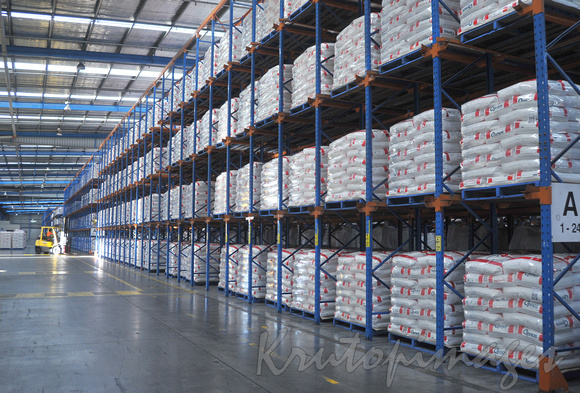 Racks of product in huge storage facility.
