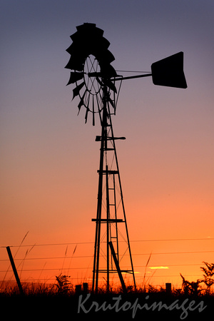 Aussie sunset and the silhouette of a irrigation windmill