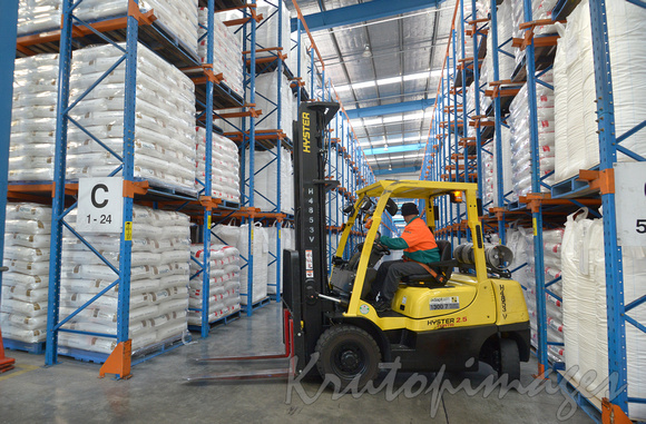 Forklift at work under roof storage facility