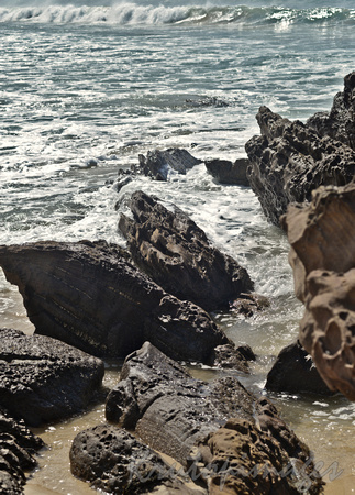 Ocean waters splash through the rocky foreshore at Pambula Beach New South Wales Australia