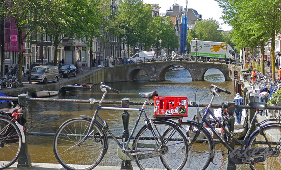 Amsterdam one of the many canals and  a couple of the many many bicycles
