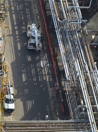 Overhead view of mobile crane and pipework at a refinery during shutdown