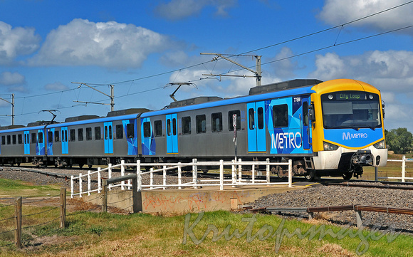 Metro train speeds through open area back to Melbourne