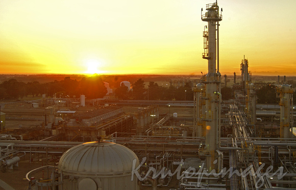 REfinery in the west as the sun sets high angle