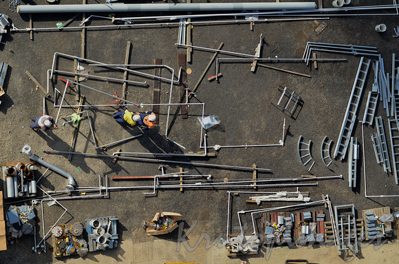 aerial-Construction workers sort components in a storage yard on site-2