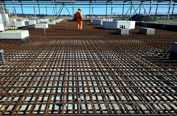 steel reinforcing is laid prior to concrete pouring on a refinery building site.