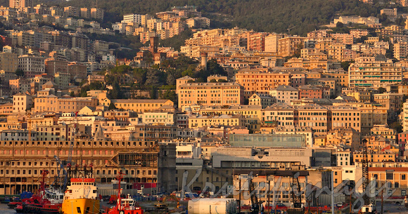 The city of Genoa at sunset seen from the harbour during a cruise