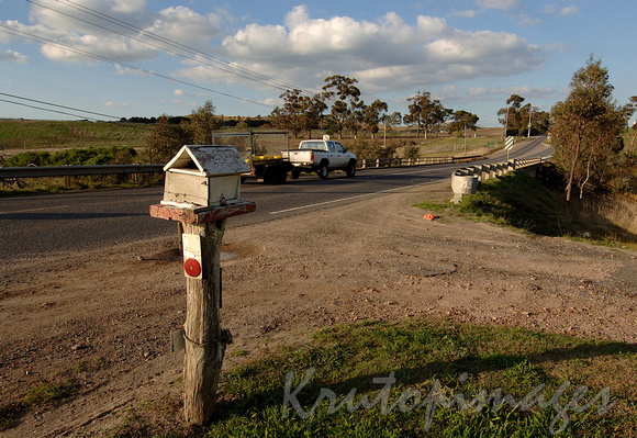 letterbox on the side of a country road as a ute passes-Victoria