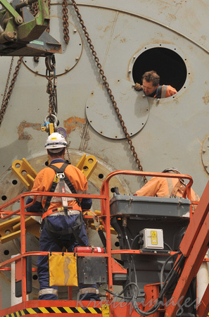 workers during maintenance of dredger onsite Yallourn W- showing confined space worker