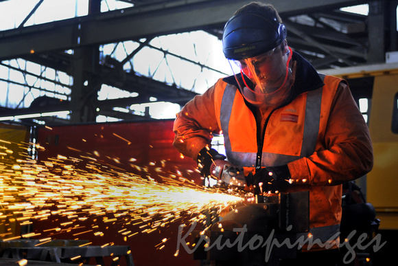 Angle Grinder in use worker in PPE.