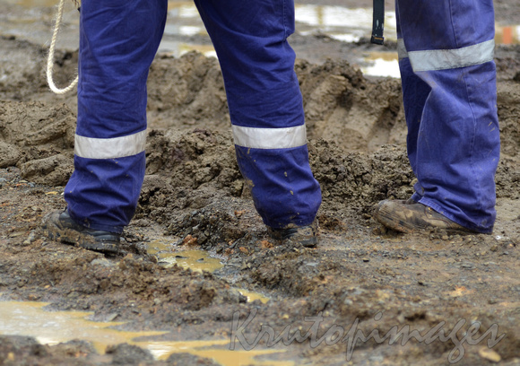 workers in mud- ppe